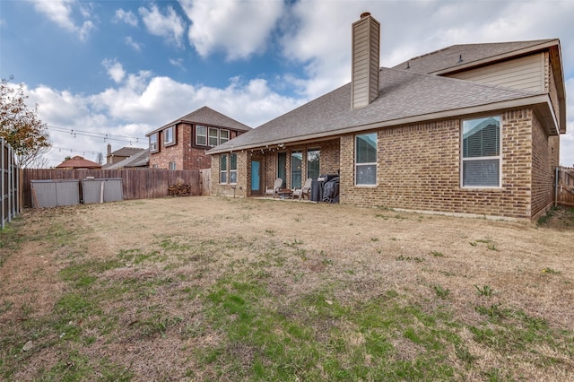 rear view of house with a yard