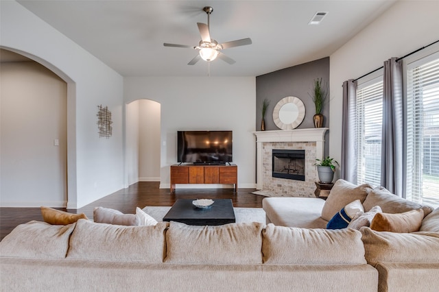 living room featuring ceiling fan and dark hardwood / wood-style flooring