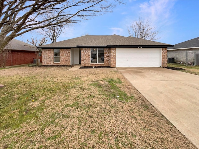 single story home featuring a garage and a front yard