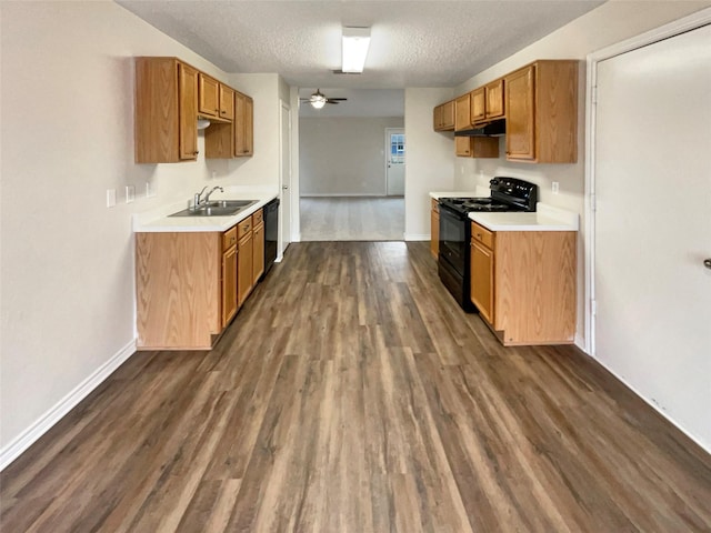 kitchen featuring dark wood-type flooring, sink, a textured ceiling, ceiling fan, and black appliances