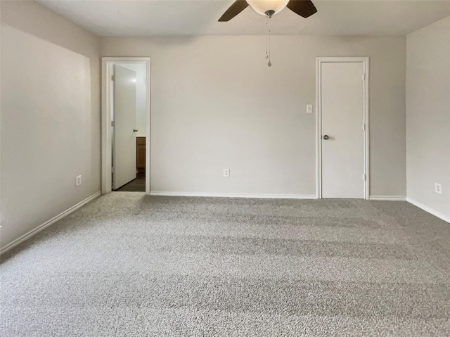 carpeted spare room with ceiling fan