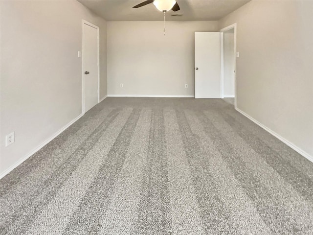 spare room featuring ceiling fan and carpet floors