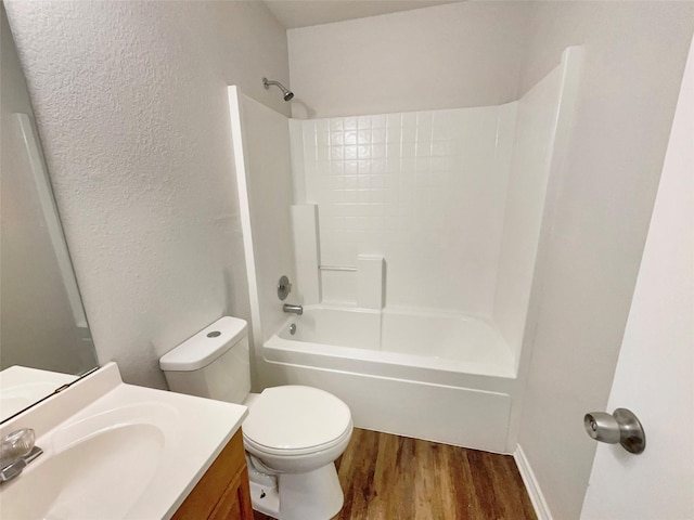 full bathroom featuring vanity, wood-type flooring, bathing tub / shower combination, and toilet