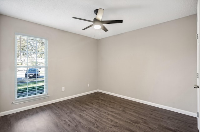 empty room with ceiling fan, a textured ceiling, and dark hardwood / wood-style flooring