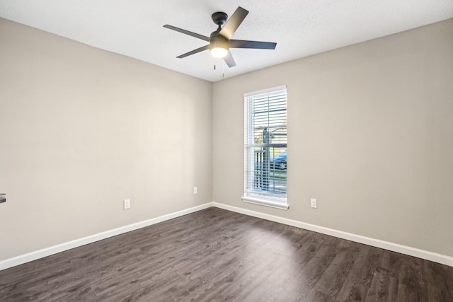 empty room featuring ceiling fan and dark hardwood / wood-style floors