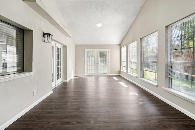 unfurnished sunroom featuring vaulted ceiling and french doors