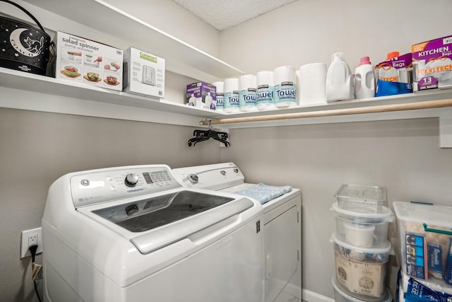 laundry area with washing machine and clothes dryer