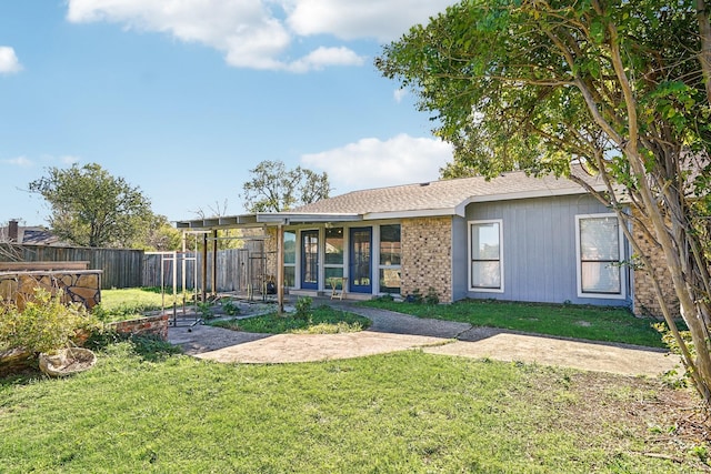 rear view of house featuring a lawn