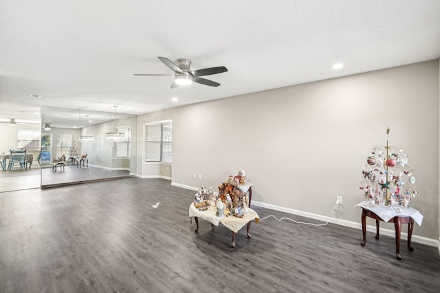 unfurnished room featuring dark wood-type flooring, a wealth of natural light, and ceiling fan