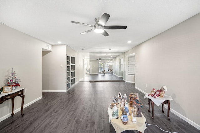 living room with dark hardwood / wood-style floors and ceiling fan