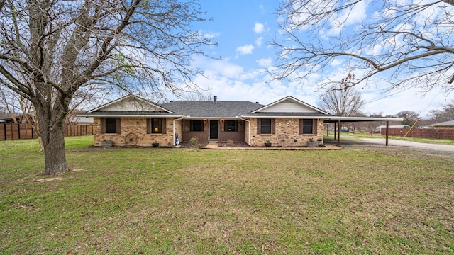 view of front facade featuring a carport and a front yard