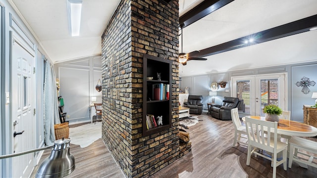 living room with hardwood / wood-style flooring, vaulted ceiling, ceiling fan, and french doors