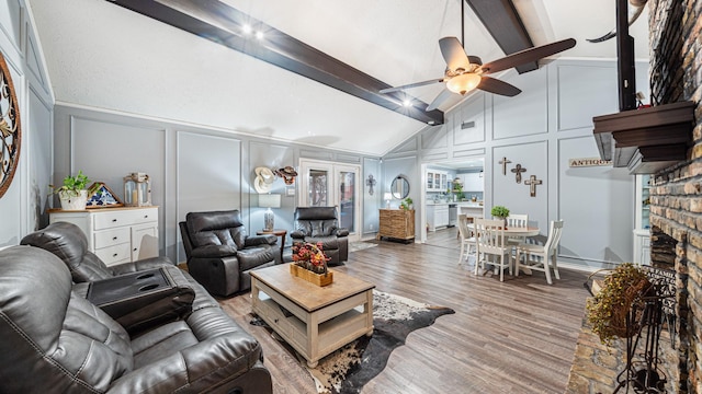 living room featuring beamed ceiling, high vaulted ceiling, hardwood / wood-style floors, and ceiling fan