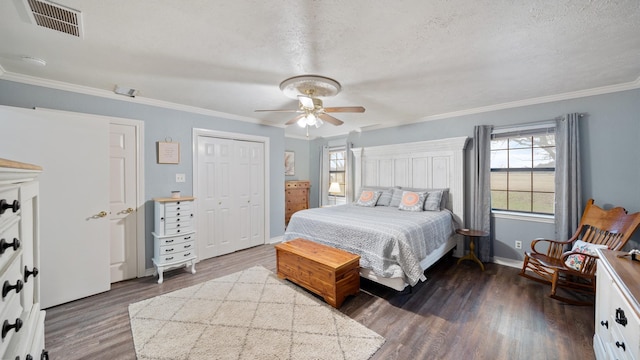 bedroom with dark hardwood / wood-style flooring, ceiling fan, crown molding, and a textured ceiling