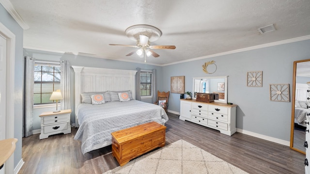 bedroom with crown molding, dark wood-type flooring, a textured ceiling, and ceiling fan