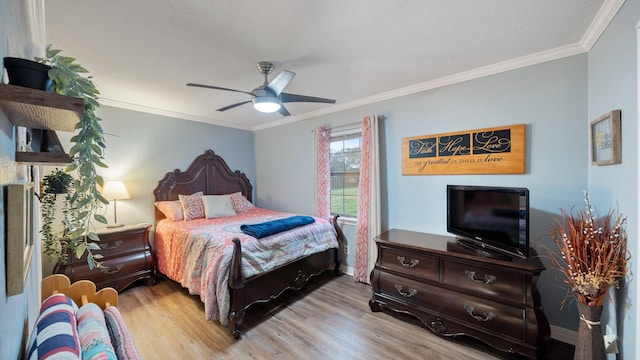 bedroom with crown molding, light hardwood / wood-style flooring, and ceiling fan