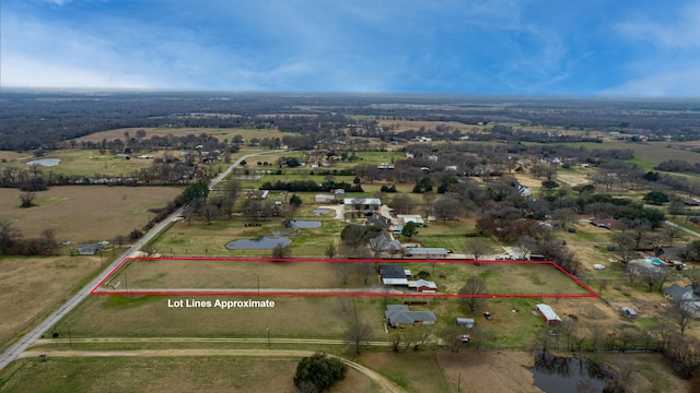 birds eye view of property featuring a rural view and a water view