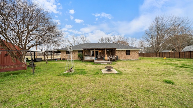 back of house with a lawn