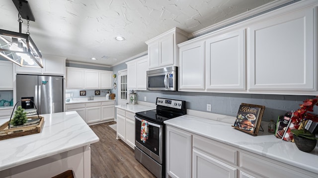 kitchen with appliances with stainless steel finishes, dark hardwood / wood-style floors, pendant lighting, white cabinets, and light stone countertops