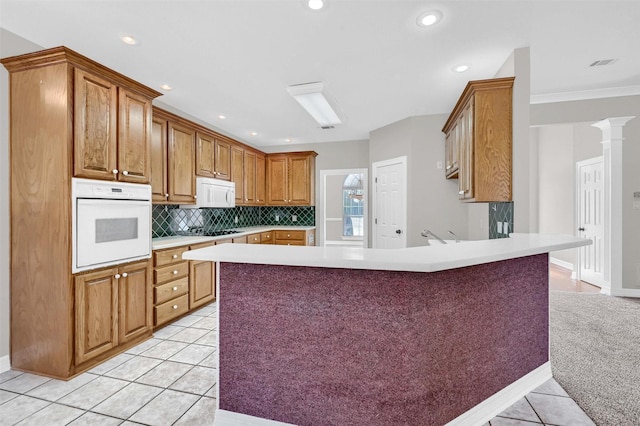 kitchen featuring backsplash, white appliances, ornate columns, crown molding, and light tile patterned flooring