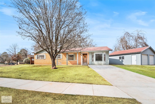 ranch-style house with a garage, an outbuilding, and a front lawn