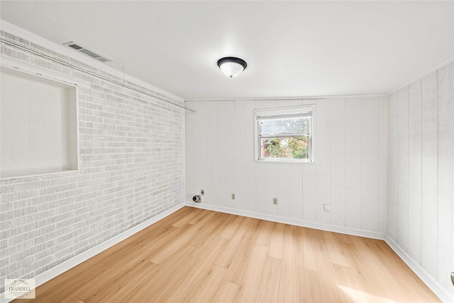 4725 Bruce St, Bossier City, LA 71111 - empty room featuring brick wall and light hardwood / wood-style floors
