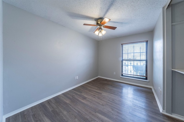 spare room with ceiling fan, dark hardwood / wood-style floors, and a textured ceiling