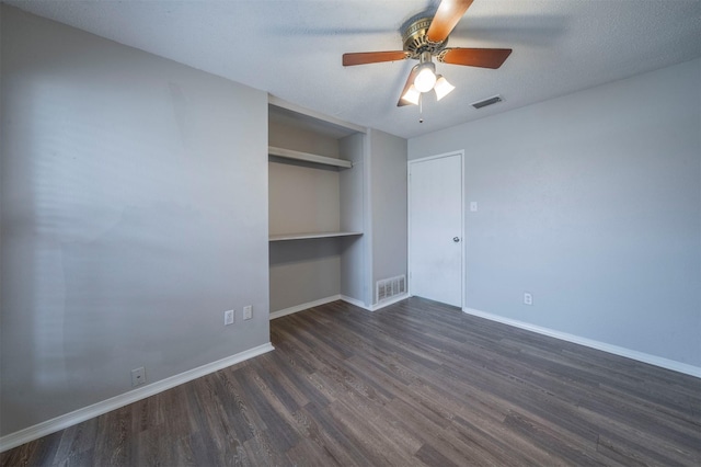 unfurnished bedroom with ceiling fan, a textured ceiling, dark hardwood / wood-style flooring, and a closet