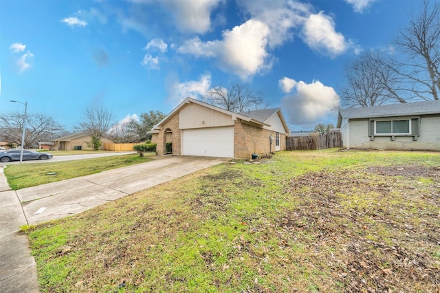 view of side of property with a garage and a lawn