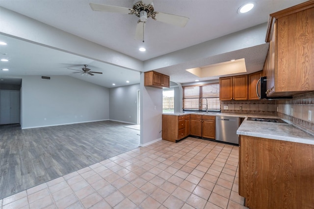 kitchen featuring tasteful backsplash, lofted ceiling, light tile patterned floors, ceiling fan, and stainless steel appliances