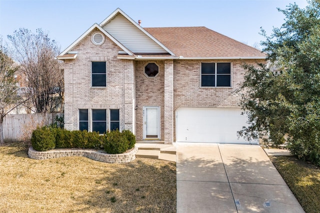 view of property featuring a garage and a front lawn