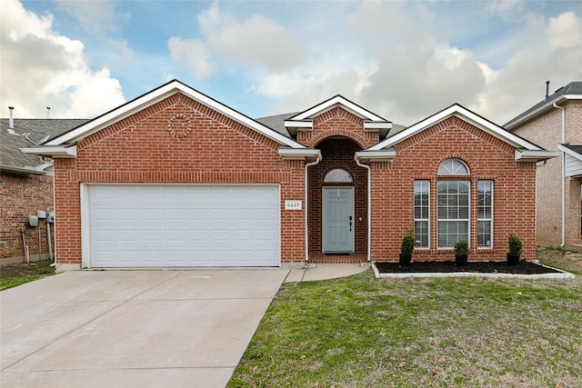 view of property featuring a garage and a front lawn