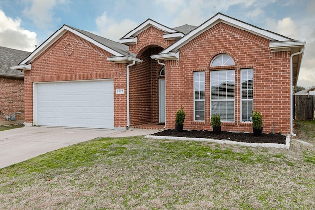 front facade with a garage and a front lawn