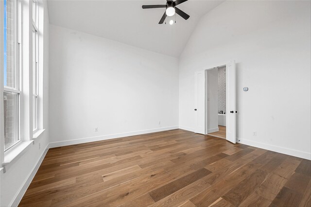 unfurnished room featuring vaulted ceiling, ceiling fan, and wood-type flooring