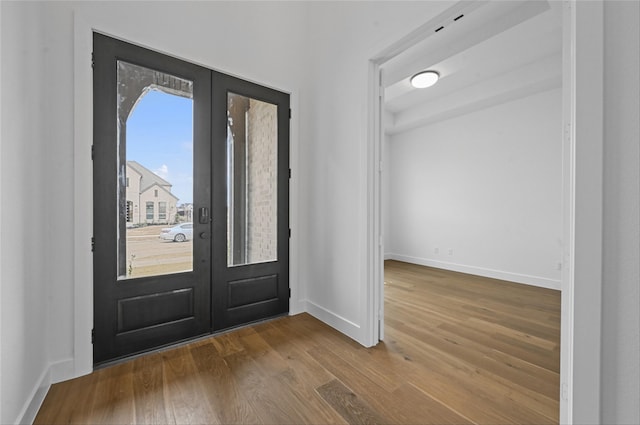 foyer entrance featuring french doors and hardwood / wood-style flooring