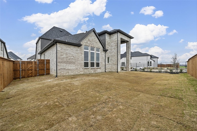 rear view of property with a yard