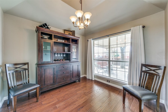 sitting room featuring a chandelier, wood finished floors, and baseboards