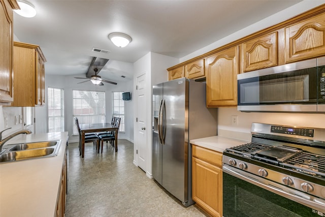 kitchen featuring visible vents, stainless steel appliances, light countertops, light floors, and a sink