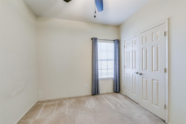 empty room with light carpet and ceiling fan