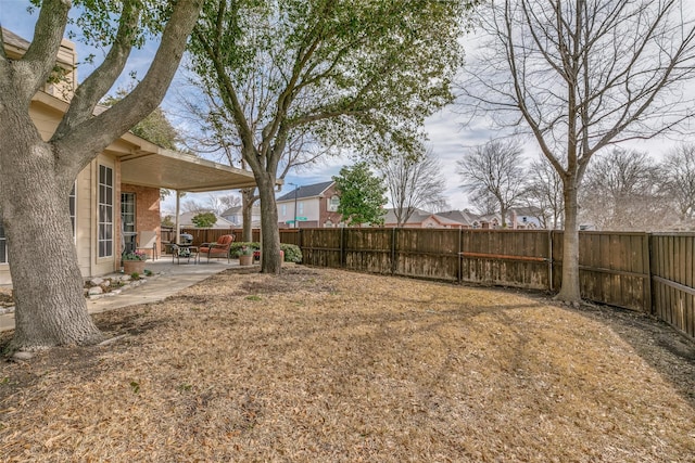 view of yard with a fenced backyard and a patio