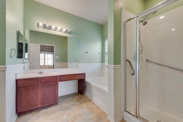 bathroom with vanity and separate shower and tub