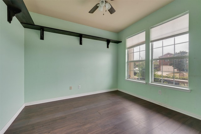 empty room with dark wood-type flooring and ceiling fan