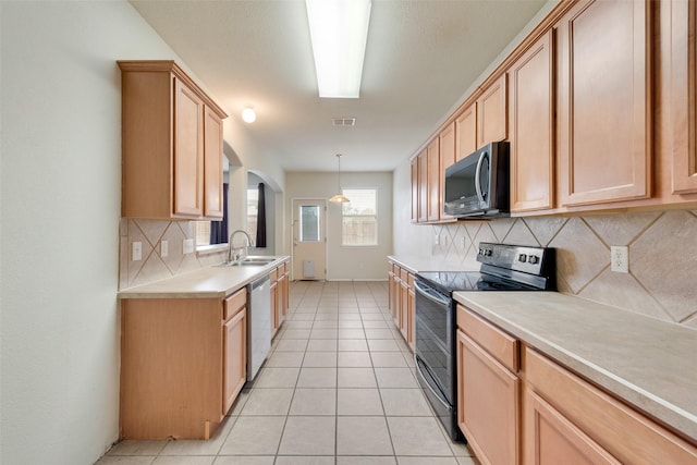 kitchen featuring pendant lighting, sink, stainless steel appliances, light tile patterned flooring, and light brown cabinetry