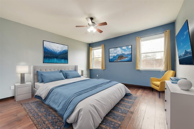 bedroom with ceiling fan and dark hardwood / wood-style floors