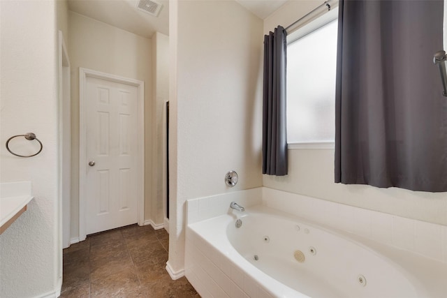 bathroom with tiled tub