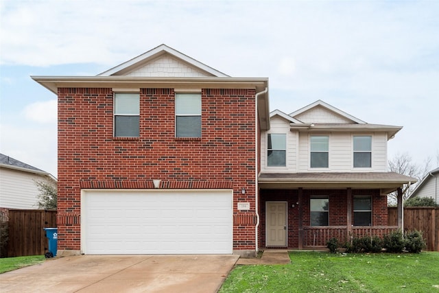 view of front property featuring a garage, a front yard, and a porch