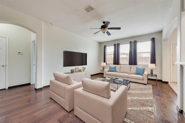 living room with dark wood-type flooring and ceiling fan