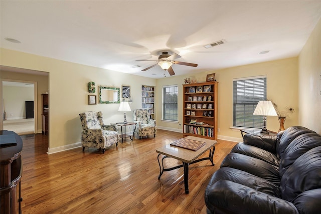 living room featuring hardwood / wood-style flooring and ceiling fan