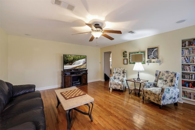 living room featuring hardwood / wood-style floors and ceiling fan