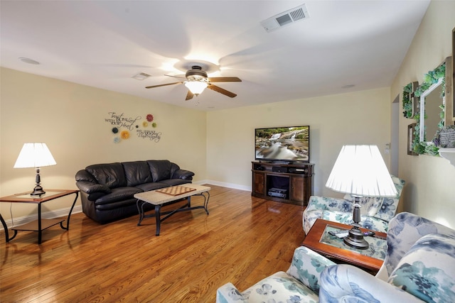 living room featuring hardwood / wood-style flooring and ceiling fan